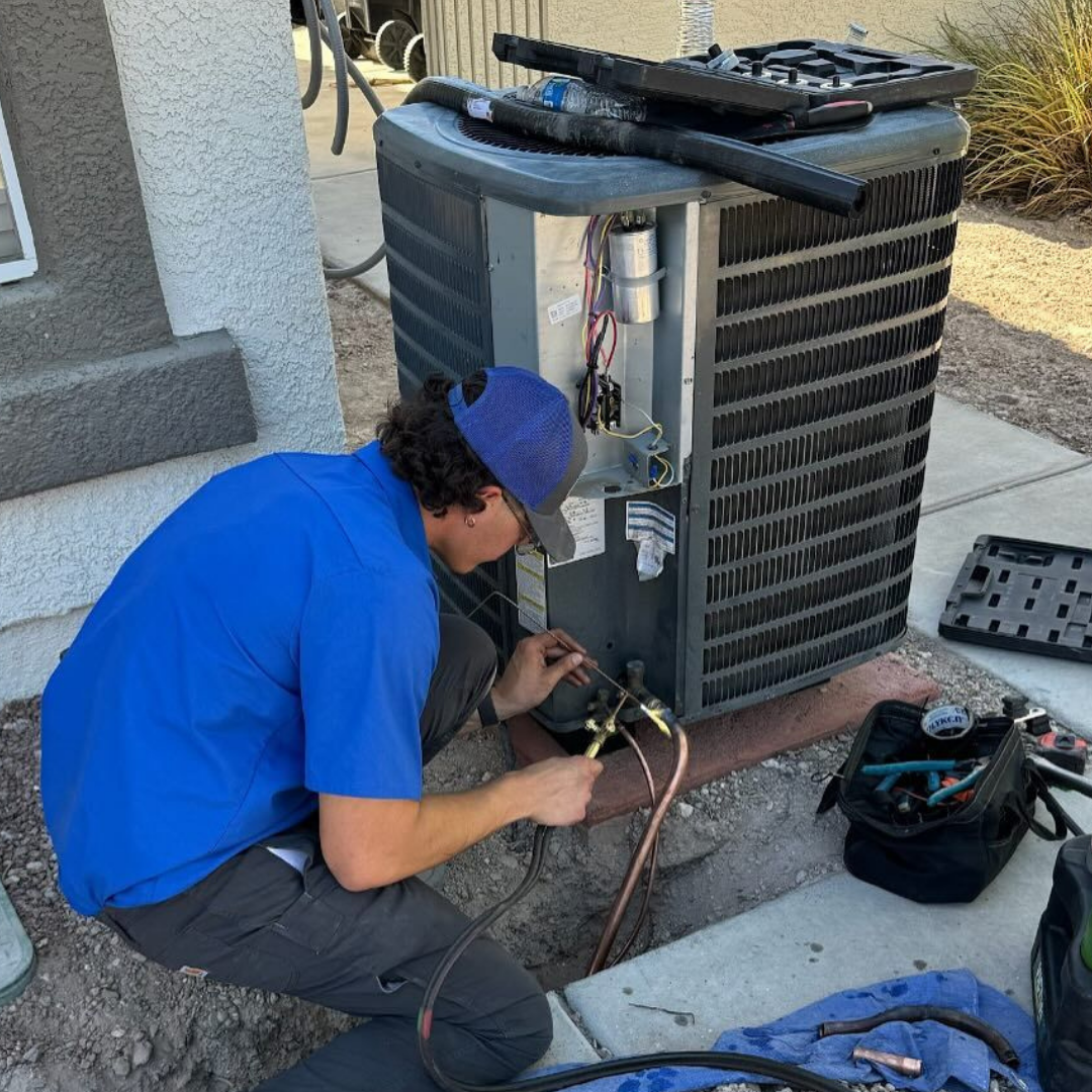 HVAC technician recovering refrigerant during an AC repair call