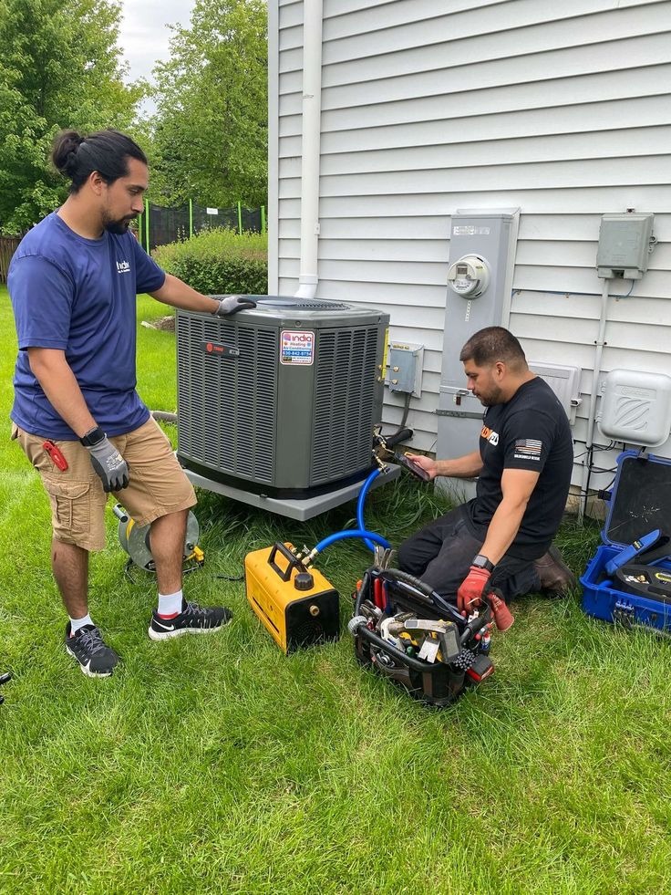 TrueLocalPros HVAC technicians servicing a Trane AC condenser in a Central Florida backyard